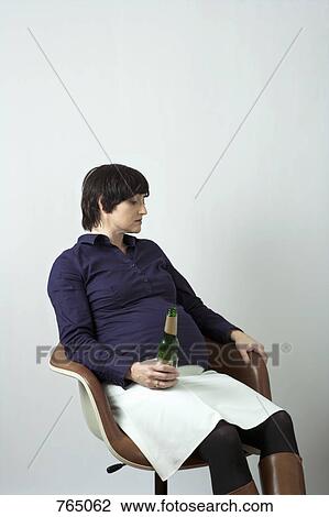 A pregnant woman holding a beer bottle View Large Photo Image Stock Image - A pregnant woman holding a beer bottle. Fotosearch
