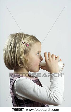 Stock Photo - A young girl drinking a glass of milk. Fotosearch