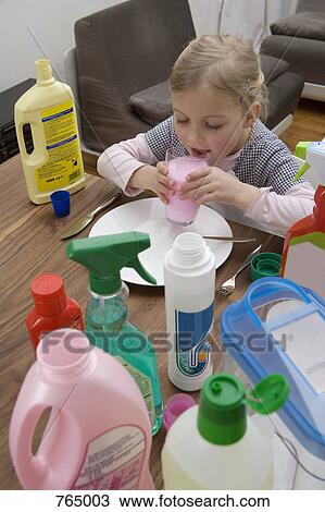 A young girl drinking cleaning fluid surrounded by medicines View Large Photo Image Stock Image - A young girl drinking cleaning fluid surrounded by medicines. Fotosearch