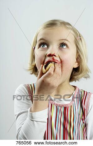 Stock Photograph - A young girl eating bread and jam. Fotosearch
