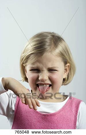 A young girl grimacing View Large Photo Image Stock Photo - A young girl grimacing. Fotosearch