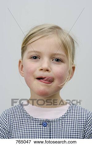 A young girl licking her lips View Large Photo Image Stock Photo - A young girl licking her lips. Fotosearch