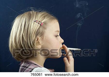Stock Photography of A young girl smoking a cigarette 
