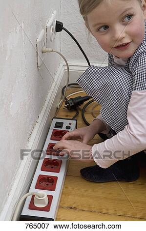 A young girl touching an electric outlet View Large Photo Image Stock Photo - A young girl touching an electric outlet. Fotosearch
