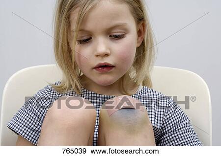 A young girl with a adhesive bandage on her knee View Large Photo Image Stock Photo - A young girl with a adhesive bandage on her knee. Fotosearch