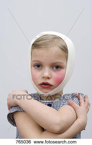 Stock Photograph - A young girl with a head injury and cheek injury. Fotosearch