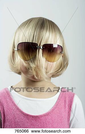 A young girl with her hair covering her face and wearing sunglasses View Large Photo Image Stock Photograph - A young girl with her hair covering her face and wearing sunglasses. Fotosearch