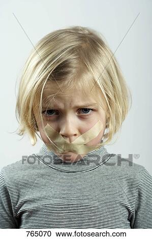Stock Image - A young girl with tape over her mouth. Fotosearch