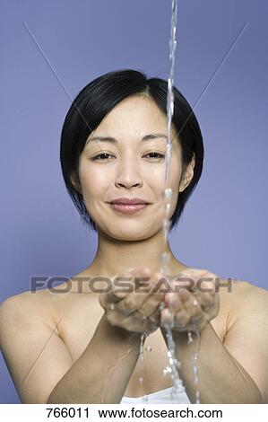 A woman cupping her hands to catch falling water View Large Photo Image Stock Image - A woman cupping her hands to catch falling water. Fotosearch