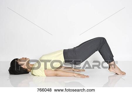 Stock Photo - A woman exercising. Fotosearch
