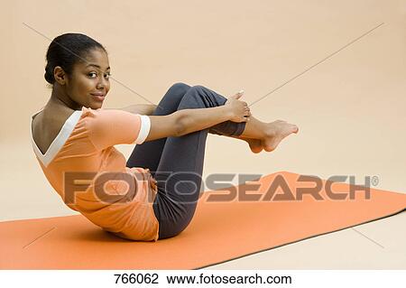 A young woman doing exercises View Large Photo Image Stock Image - A young woman doing exercises. Fotosearch