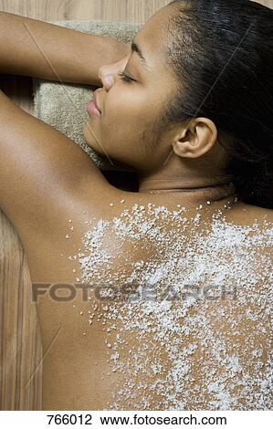 A young woman lying on front having a spa treatment View Large Photo Image Stock Image - A young woman lying on front having a spa treatment. Fotosearch