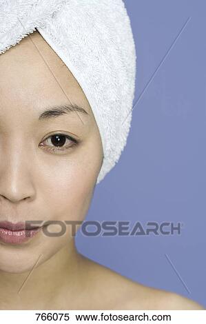 Portrait of a woman with a towel wrapped around her hair View Large Photo Image Stock Photography - Portrait of a woman with a towel wrapped around her hair. Fotosearch