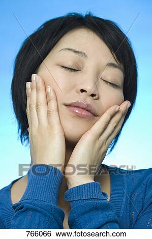 Stock Photograph - Portrait of a woman with her eyes closed. Fotosearch