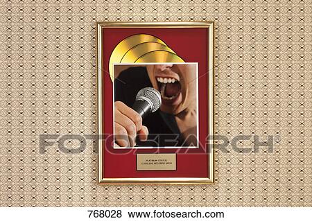 A photograph of a person singing on top of a framed gold record View Large Photo Image Stock Photo - A photograph of a person singing on top of a framed gold record. Fotosearch