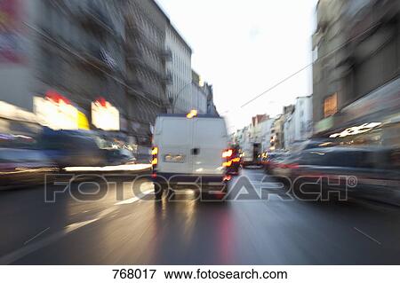 Traffic driving along a street View Large Photo Image Stock Photo - Traffic driving along a street. Fotosearch