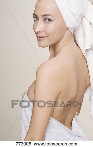A portrait of a woman wrapped in a towel looking coy View Large Photo Image Stock Photography - A portrait of a woman wrapped in a towel looking coy. Fotosearch