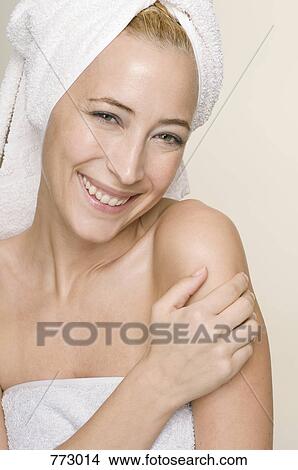 A woman wrapped in a towel smiling, portrait View Large Photo Image Picture - A woman wrapped in a towel smiling, portrait. Fotosearch