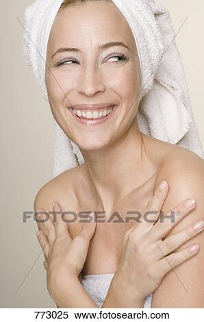 A woman wrapped in a towel smiling, portrait View Large Photo Image Stock Photography - A woman wrapped in a towel smiling, portrait. Fotosearch