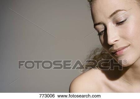 Beauty shot of a woman looking down View Large Photo Image Stock Photograph - Beauty shot of a woman looking down. Fotosearch