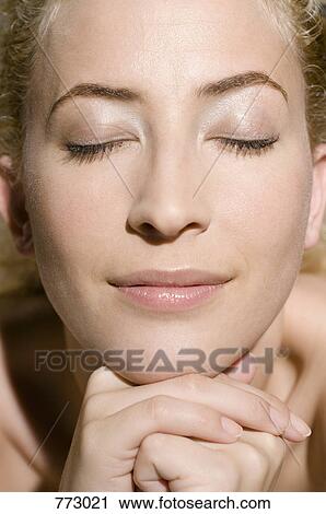 Stock Image - Beauty shot of a woman with her eyes closed. Fotosearch