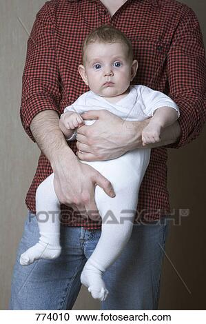 A father holding his baby son View Large Photo Image Stock Image - A father holding his baby son. Fotosearch