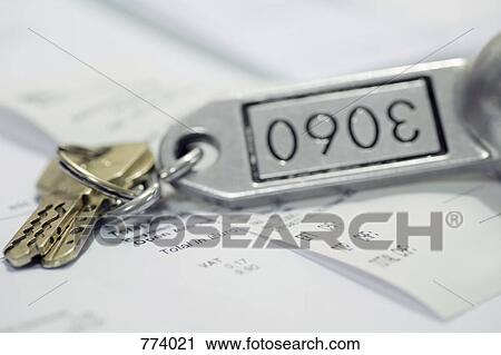 A hotel key and a receipt View Large Photo Image Stock Image - A hotel key and a receipt. Fotosearch