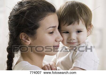 Portrait of a young mother and young son View Large Photo Image Stock Photo - Portrait of a young mother and young son. Fotosearch