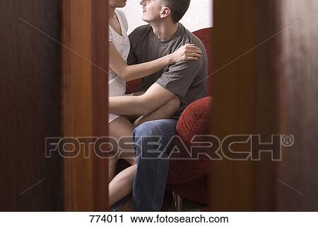 Spying through a crack in the door at a couple sharing an intimate moment View Large Photo Image Stock Image - Spying through a crack in the door at a couple sharing an intimate moment. Fotosearch