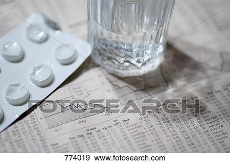 The financial page, a blister pack and a glass of water View Large Photo Image Stock Photo - The financial page, a blister pack and a glass of water. Fotosearch