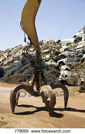 A hydraulic crane in a scrap metal yard View Large Photo Image Stock Photography - A hydraulic crane in a scrap metal yard. Fotosearch