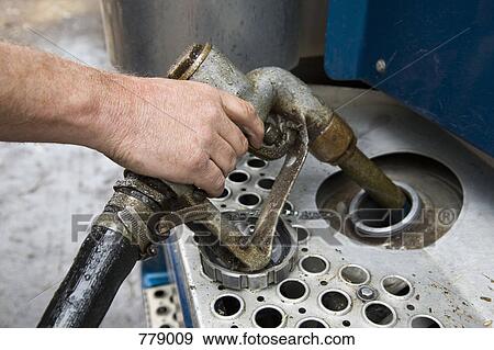 A man filing a petrol tank View Large Photo Image Stock Photo - A man filing a petrol tank. Fotosearch
