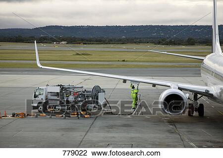 An airplane being refueled on the tarmac View Large Photo Image Stock Image - An airplane being refueled on the tarmac. Fotosearch