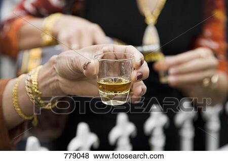 Hands holding drinks at a social gathering View Large Photo Image Stock Photo - Hands holding drinks at a social gathering. Fotosearch