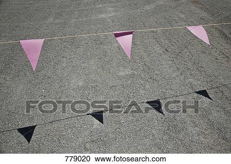 Pink bunting hanging above a road View Large Photo Image Stock Image - Pink bunting hanging above a road. Fotosearch