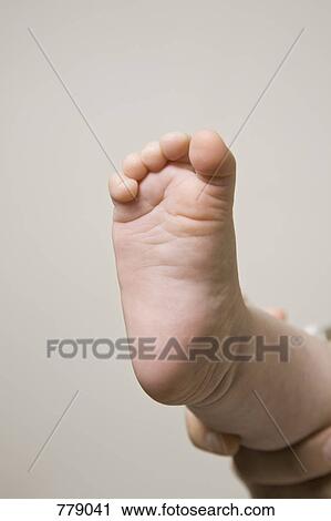Stock Image - The foot of a baby. Fotosearch