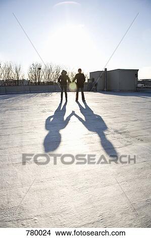A woman and a man holding hands on a roof View Large Photo Image Picture - A woman and a man holding hands on a roof. Fotosearch