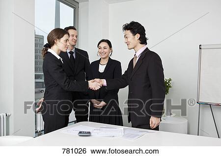 Business people shaking hands after a meeting View Large Photo Image Stock Photograph - Business people shaking hands after a meeting. Fotosearch