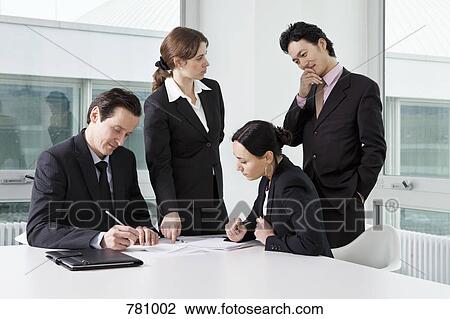 Four business people in a business meeting View Large Photo Image Stock Image - Four business people in a business meeting. Fotosearch