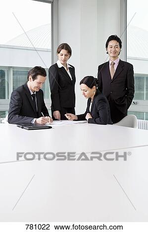 Four business people in a business meeting View Large Photo Image Stock Image - Four business people in a business meeting. Fotosearch