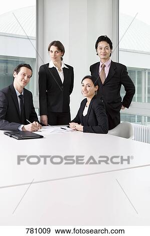 Portrait of four business people in a meeting View Large Photo Image Stock Photo - Portrait of four business people in a meeting. Fotosearch