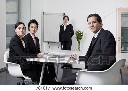 Portrait of four business people in a meeting View Large Photo Image Stock Photo - Portrait of four business people in a meeting. Fotosearch