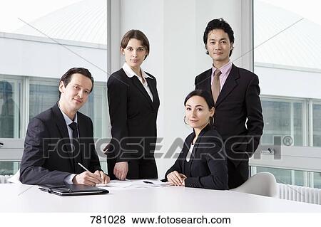 Portrait of three business people in a meeting View Large Photo Image Stock Photo - Portrait of three business people in a meeting. Fotosearch