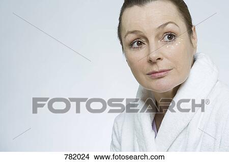 A woman applying face cream View Large Photo Image Picture - A woman applying face cream. Fotosearch