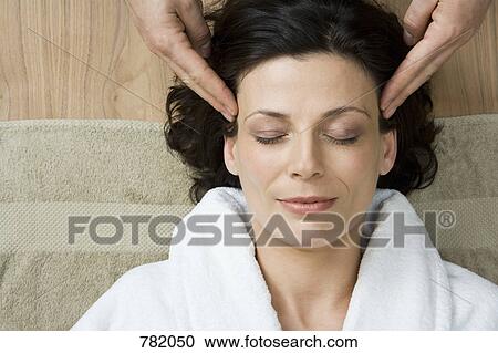 A woman having a head massage View Large Photo Image Stock Image - A woman having a head massage. Fotosearch