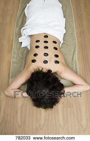 A woman having hot stone therapy treatment View Large Photo Image Stock Image - A woman having hot stone therapy treatment. Fotosearch