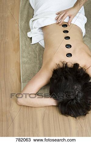 A woman having hot stone therapy treatment View Large Photo Image Stock Image - A woman having hot stone therapy treatment. Fotosearch