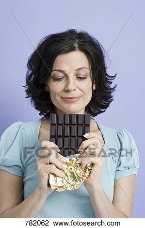 A woman holding a chocolate bar, View Large Photo Image Stock Image - A woman holding a chocolate bar, . Fotosearch