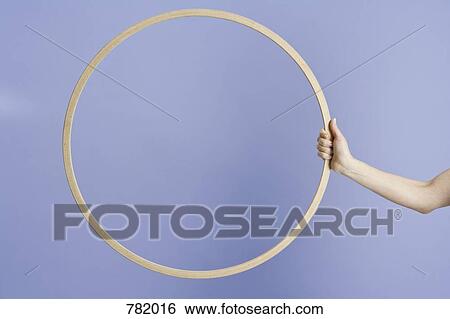 A woman holding a plastic hoop View Large Photo Image Stock Photograph - A woman holding a plastic hoop. Fotosearch