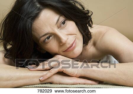 A woman relaxing lying on her front View Large Photo Image Stock Photo - A woman relaxing lying on her front. Fotosearch